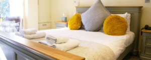 Comfortable king-size bed in ground floor double room sevem at The Stiffkey Red Lion