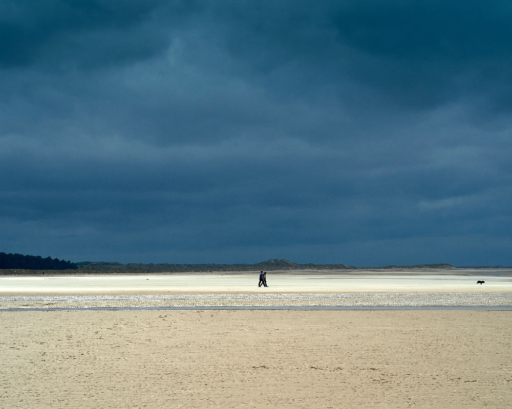 Deserted Holkham Beack with couple and dog